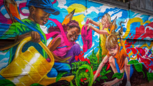 Anieken Udofia mural of diverse group of children watering garden together