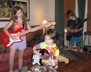 My kids, attached to each other ... and their guitars.